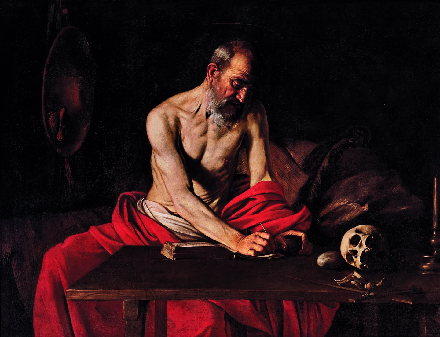 Caravaggio: sveti Jeronim u crvenom plaštu nagnuo se nad stol i piše, a pokraj njega leži lubanja.